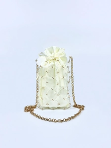 Detail of sequin mesh exterior and satin drawstring lining on mini bucket bag