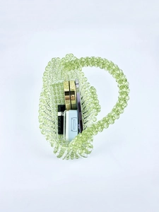 Green acrylic beaded mini bag showing capacity for lipstick, powder, and phone