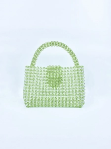Macro detail of handmade green acrylic beaded handbag with woven translucent beads