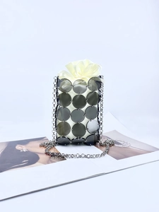 Sparkly metal sequin bucket bag with drawstring liner and silver chain shoulder strap