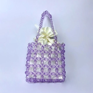 Detail of purple beaded handmade handbag with cream satin drawstring inner pouch