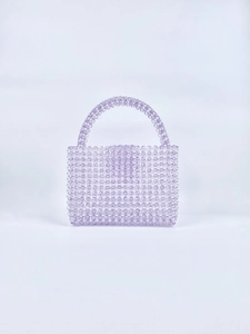 Detailed close-up of light purple handmade acrylic beaded handbag showing bead texture