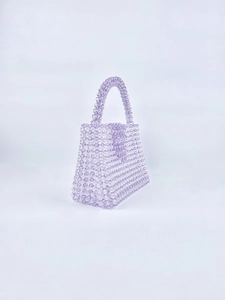 Close-up of handmade lavender acrylic beaded handbag showing intricate weave and texture