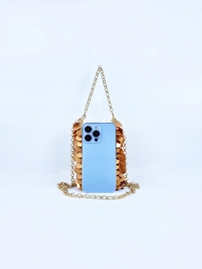 Detail of gold sequin phone bag with metal ring chain and blue smartphone inside