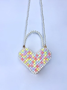 Detail of a handmade heart-shaped beaded mini bag with pastel acrylic beads and pearls