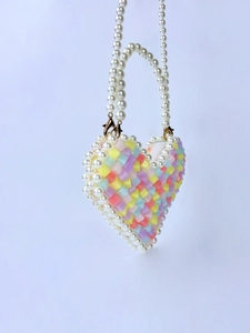 Detailed macro view of heart-shaped beaded mini bag with colorful translucent cubes