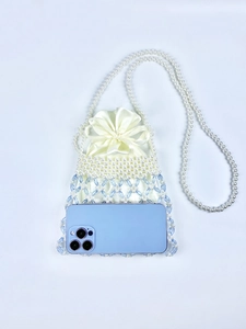 Detail of beaded mini bag with satin drawstring pouch and pearl shoulder strap for phones