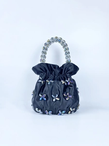 Detail of black satin bucket bag with crystal flower beads and chunky beaded handle