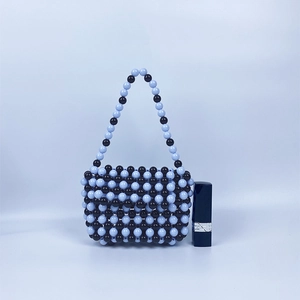 Détail d'un mini sac à main en perles fait main bleu et noir avec rouge à lèvres témoin
