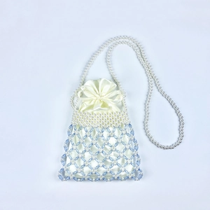 Detail of handcrafted blue and white pearl beaded bag with satin drawstring pouch