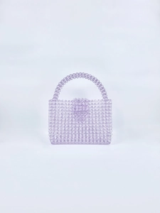 Detail of lavender acrylic beaded handbag showing the texture and handle craft