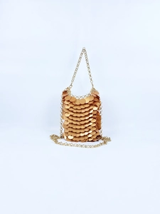 Detailed view of the gold sequin handbag featuring a metallic scale-like texture and chain