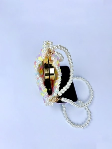 Close-up of handmade rainbow beaded mini bag with pearl handle and golden accessory