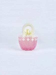 Detail of pink gradient handmade beaded bag with white faux pearl handle and satin lining