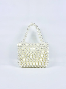 Detailed view of handmade pearl woven handbag featuring elegant double beaded handles