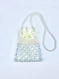 Detail of beaded bag featuring white pearls, blue crystals, and satin drawstring pouch