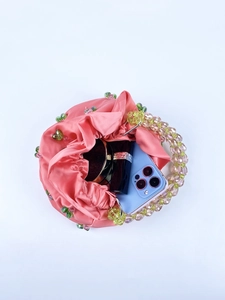 Top view of pink satin drawstring bag with beads showing interior storage capacity