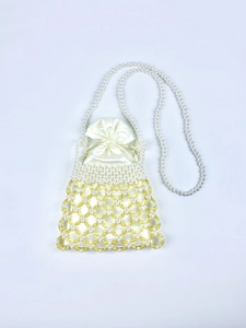 Detail of handmade woven pearl bag with yellow beads and cream satin drawstring pouch