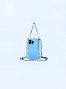 Detail of mint green sequin mini phone bag with a slim silver metal chain strap