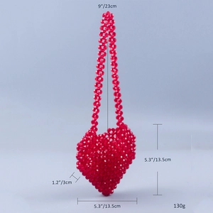 Detail view of handmade red beaded heart bag showing dimensions and crossbody strap