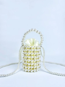 Detailed view of handmade pearl bucket bag with gold beads and satin drawstring liner