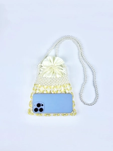 Detail of beaded pearl crossbody bag showing woven texture and size fit for a smartphone