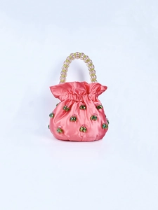 Detail of pink satin bucket bag with green crystal beads and acrylic beaded handle