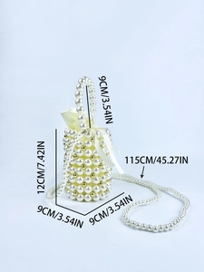 Detail of white handmade pearl bucket bag with beige drawstring pouch and gold bead accents