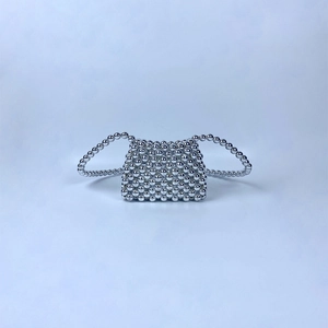 Detailed view of silver handmade beaded mini bag with metallic pearl-like finish and handle
