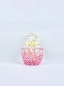 Detailed view of handmade pink beaded handbag with a pearl gradient and satin drawstring liner