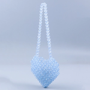 Detail of light blue heart-shaped beaded mini bag with handmade acrylic strap