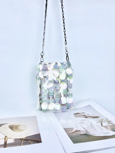 Detail of holographic sequins on the mini chain bag with fish scale texture