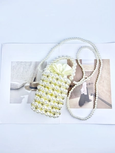 Handmade pearl bucket bag with gold beads and satin drawstring liner for elegant dinner