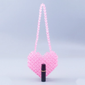 Mini pink heart beaded crossbody bag with lipstick for size comparison