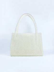 Close-up of handmade white pearl woven handbag with structured rectangular design