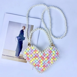 Rainbow heart beaded mini bag with pearl handle and long strap on white background