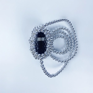 Detailed view of silver metallic beads weaving with black core and round buckle detail
