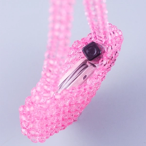Close-up of pink handmade beaded mini bag showing acrylic bead texture and lipstick storage