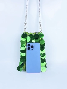 Detail of green sequin mini bag with silver chain strap and smartphone for size reference