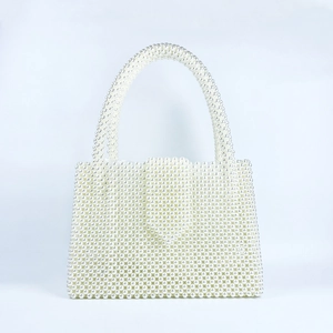 Detailed view of handmade white pearl beaded handbag with vintage woven rectangle design