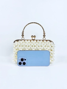 Detail of pearl evening clutch with golden circular handle and phone size comparison