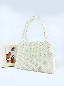 Elegant white handmade pearl beaded basket handbag with top handles and a vintage flap design