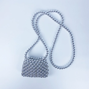 Top view of a silver beaded mini crossbody bag with an intricate woven handmade texture