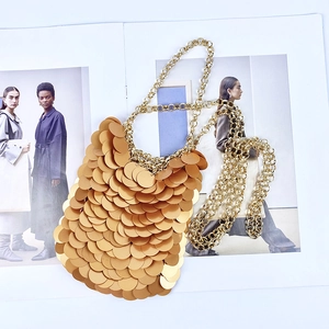 Chic gold sequin chain handbag with layered metallic discs in retro disco style
