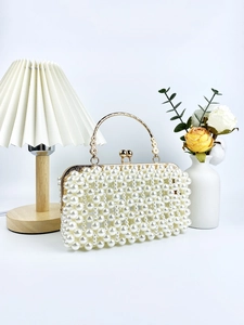 Elegant white pearl clutch bag with gold ring handle for evening parties and weddings