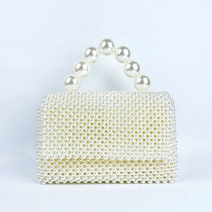 Close-up of handmade white pearl handbag with square woven texture and top handle