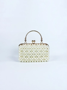 Detail of elegant pearl evening bag with gold metal frame and kiss-lock closure