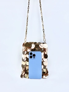 Mini gold sequin crossbody bag shown next to a smartphone for size scale comparison
