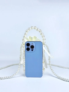 Detail of handmade pearl beaded bag with satin drawstring pouch and mobile phone capacity