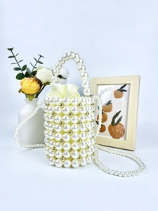 Handmade pearl bucket bag with gold accents and drawstring satin lining for parties